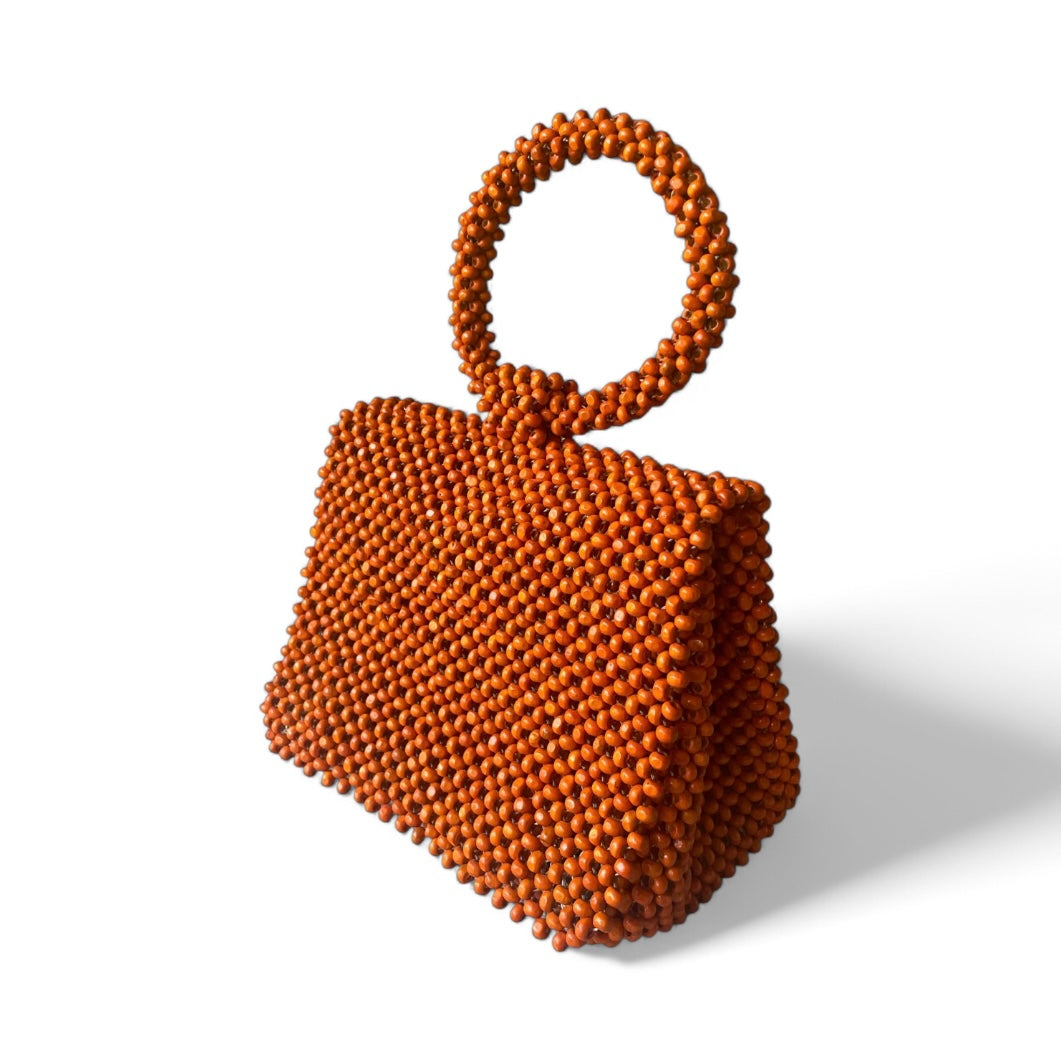 The Beatriz Beaded Handbag in color orange. Ideal accessory for special events such as weddings, gala, or ball.