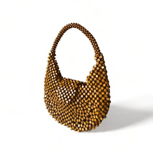 The Carmela handmade statement bag in Washed Brown color, made from wooden beads.