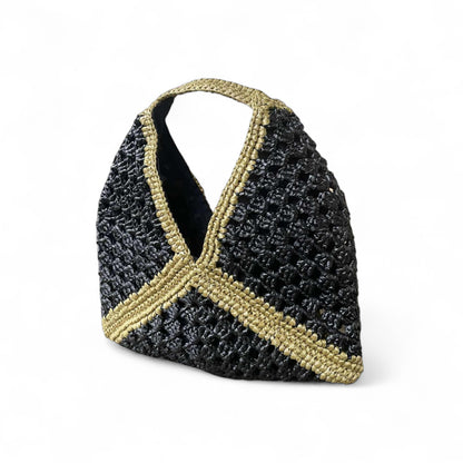 Black and gold woven handbag on a white background